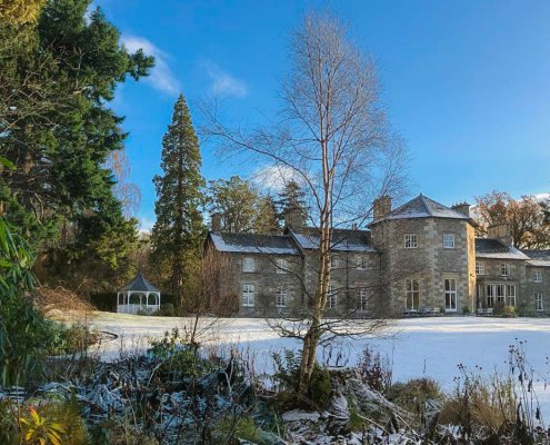 “Front view of Coul House Hotel with frosted grounds and soft winter light.”